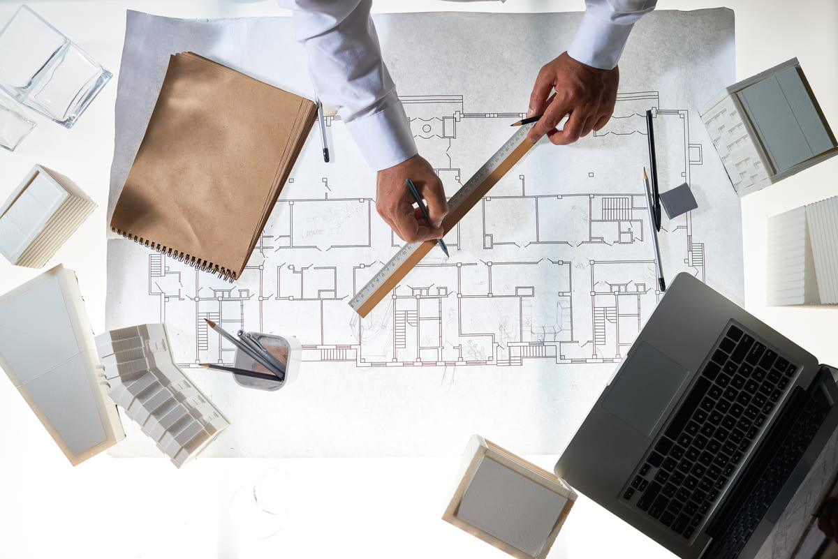 architect-drafting-blueprints-with-laptop-and-scal-2026-01-08-23-44-43-utc (1) (1)